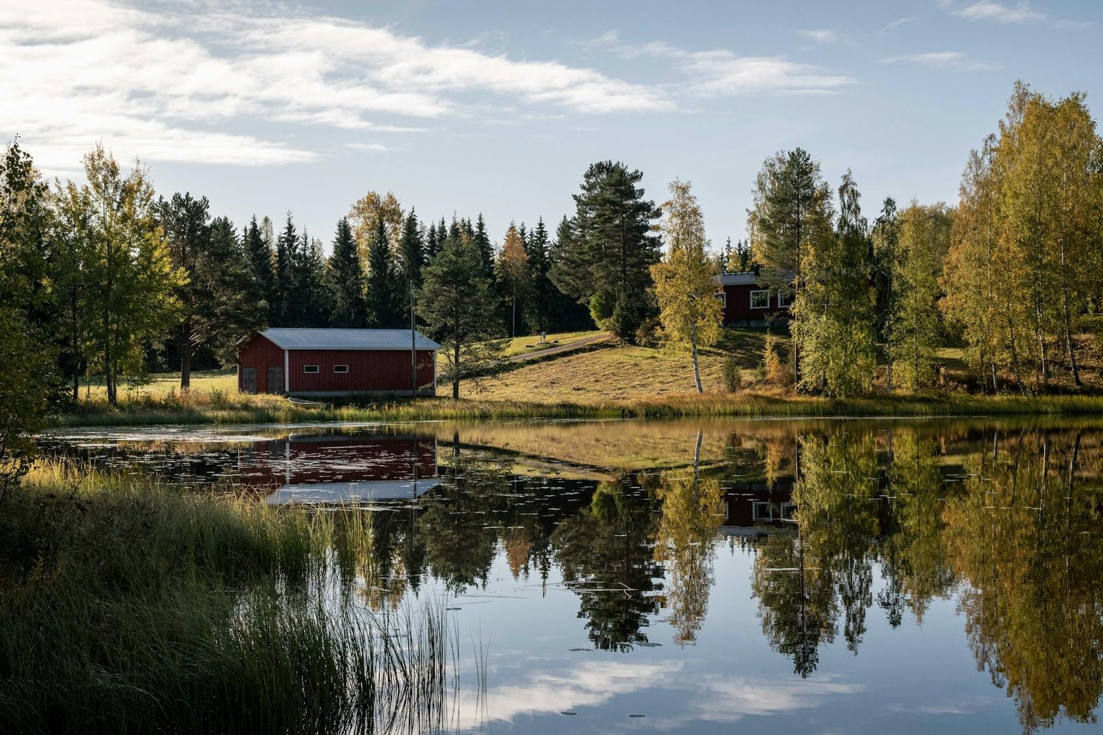 photo of lake during daytime. Finnish Midsummer Traditions